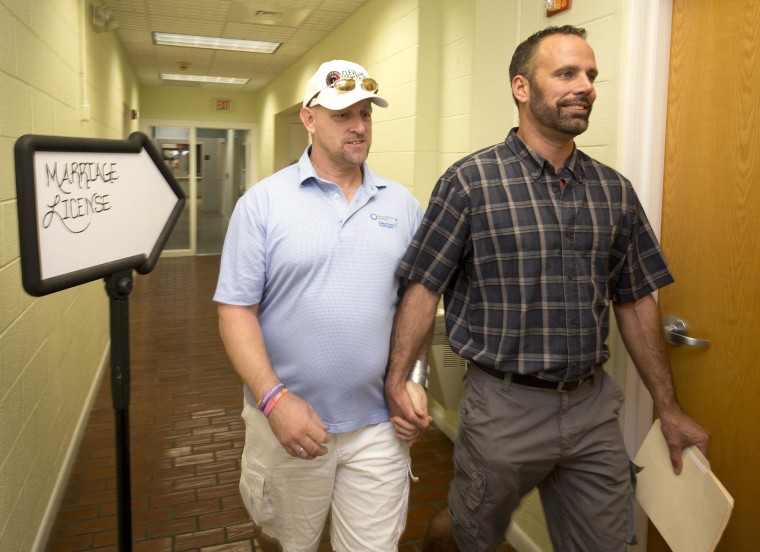 Image:  William Lee Jones (L) and Aaron Huntsman leave the Monroe County Clerk of the Court's office after completing a marriage license application on Jan. 2, in Key West, Florida.
