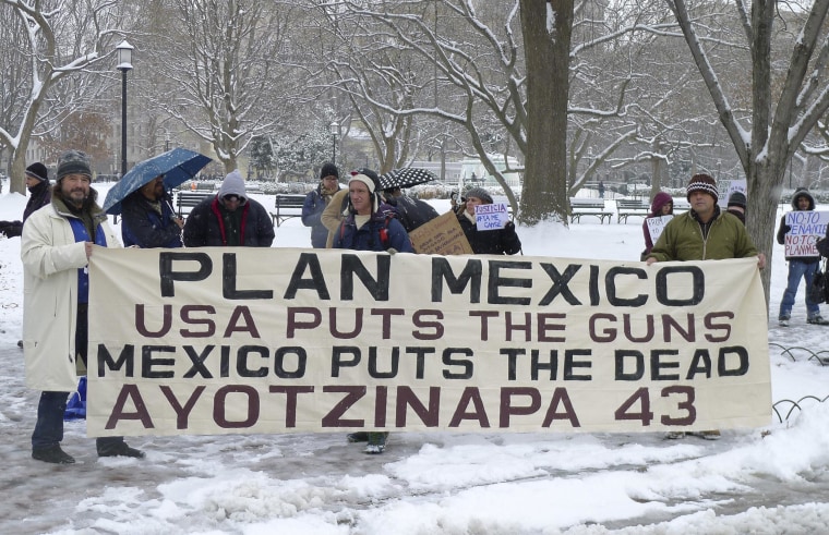 Image: Protesters hold a banner outside the White House in Washington before the arrival of Mexican President Enrique Pena Nieto