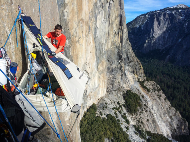 Image: Tommy Caldwell adjusts his tent while hanging off of Dawn Wall on the El Capitan mountain in California's Yosemite National Park.