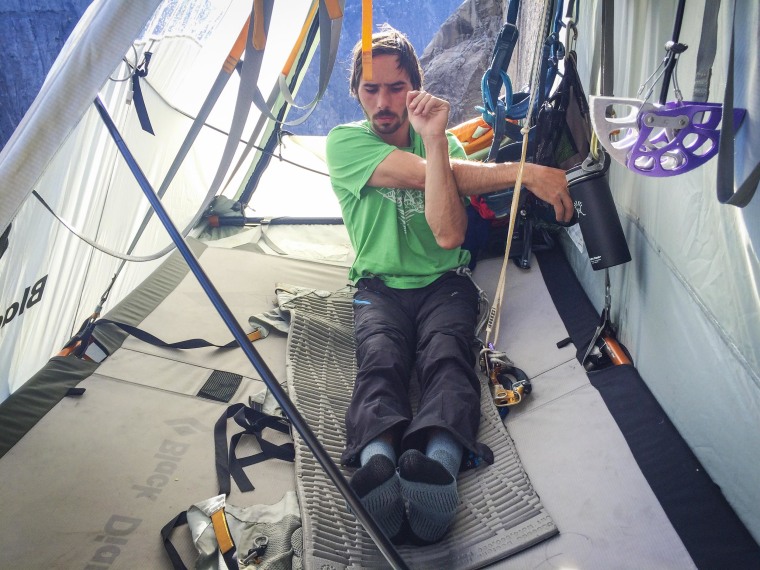 Image: Kevin Jorgeson streches while hanging off of Dawn Wall