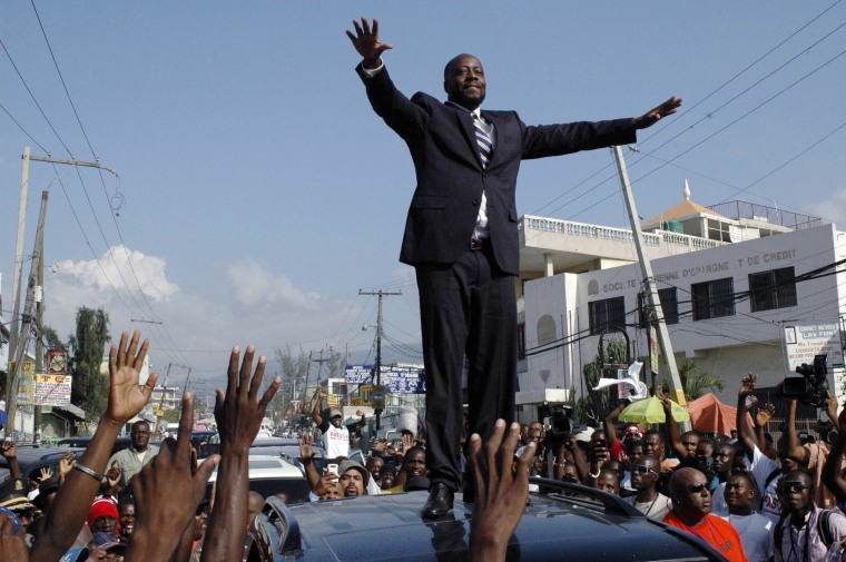 Image: Wyclef Jean greeting the crowd before officially registering as a presidential candidate in Port-au-Prince