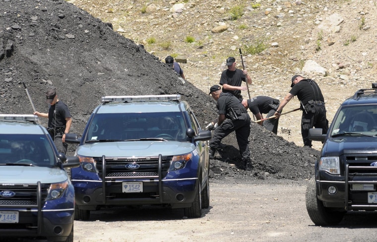 Image: Massachusetts State Police dig for evidence an industrial park in North Attleborough, Mass. on June 20, 2013