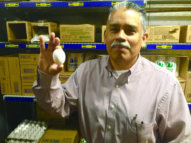 German Ustariz shows one of the fresh eggs used for McDonald's breakfasts.  He and his wife Delma own four McDonald's franchises in the greater Austin area.  He started working at McDonald's at 16 in Los Angeles, and met his wife while they both worked there. They took a chance as owner-operators, moving to Austin without knowing anyone.