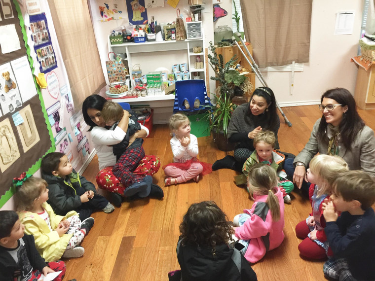 Adriana Rodriguez, second from right, joins her students in a Spanish-language song and lesson.