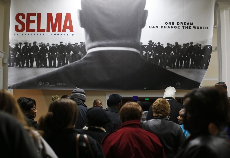 Image: Audience members line up for a screening of the movie "Selma" at the Selma Walton Theatre in Selma