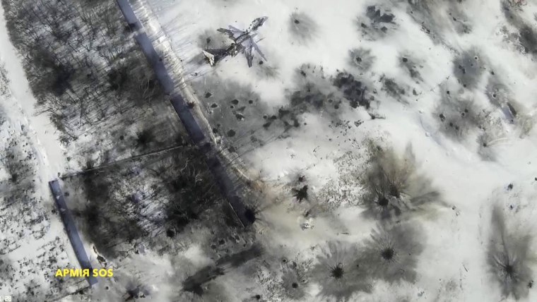 Image: Still image taken from handout aerial footage shot by drone shows outline of an airplane in the snow at Sergey Prokofiev International Airport damaged by shelling during fighting between pro-Russian separatists and Ukrainian government forces, in D