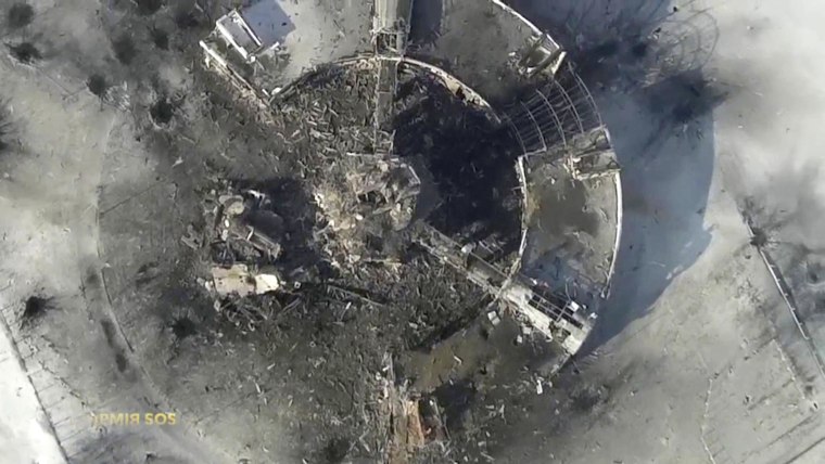 Image: Still image taken from handout aerial footage shot by a drone shows a multi-storey control tower of the Sergey Prokofiev International Airport damaged by shelling during fighting between pro-Russian separatists and Ukrainian government forces, in D