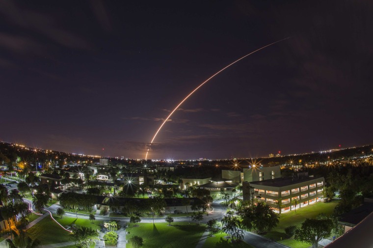 A United Launch Alliance Atlas 5 rocket blasts off from Cape Canaveral Air Force Station in Florida on Tuesday. The rocket sent up a next-generation communications satellite designed to provide cellular-like voice and data services to U.S. military forces around the world. This long-exposure view looks over the campus of the Florida Institute of Technology in Melbourne, about 40 miles from the launch pad.