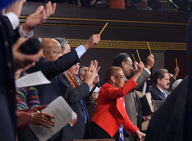 Image: Lawmakers hold up pencils during the State of the Union address