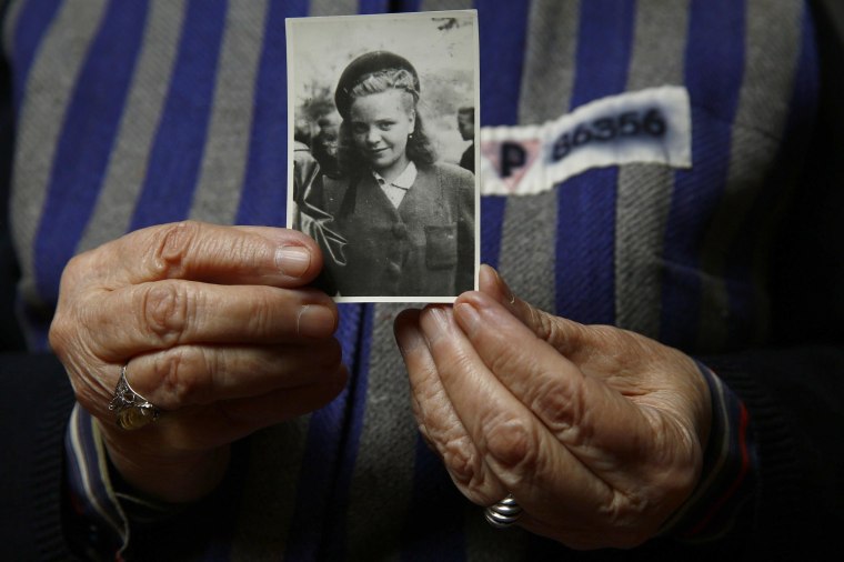 Image: Auschwitz death camp survivor Jadwiga Bogucka holds a picture of herself from 1944 in Warsaw