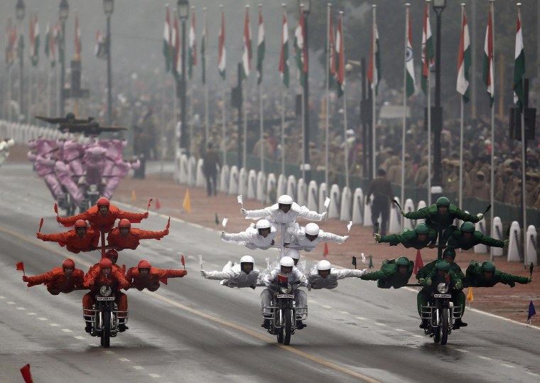 Image: India's BSF "Daredevils" motorcycle riders perform stunts as they take part during the Republic Day parade in New Delhi