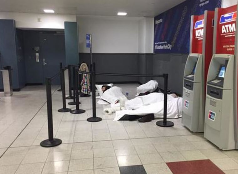 Passengers sleep on the floor at John F. Kennedy Airport after their flights were delayed.