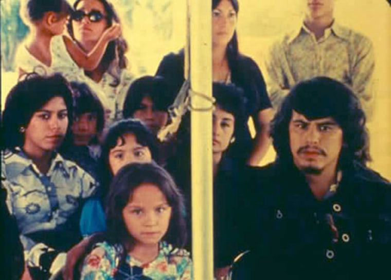 A still from the movie "Please, Don't Bury Me Alive"s opening funeral scene. The movie's maverick director, Efraín Gutiérrez, is in the black shirt at the far right, playing the lead role of Alejandro.