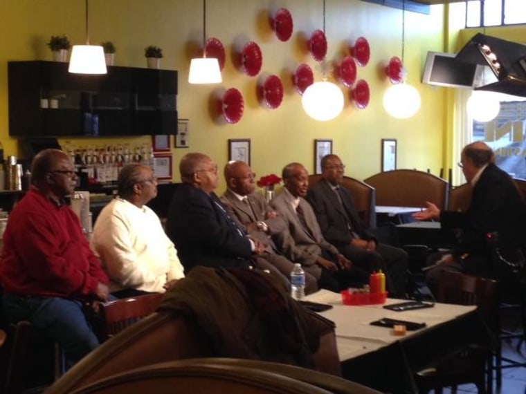 Mart Potter interviews six members of the "Friendship 9," seated at the at the very lunch counter they were jailed for occupying.  Their names are now enshrined on the backs of the stools.