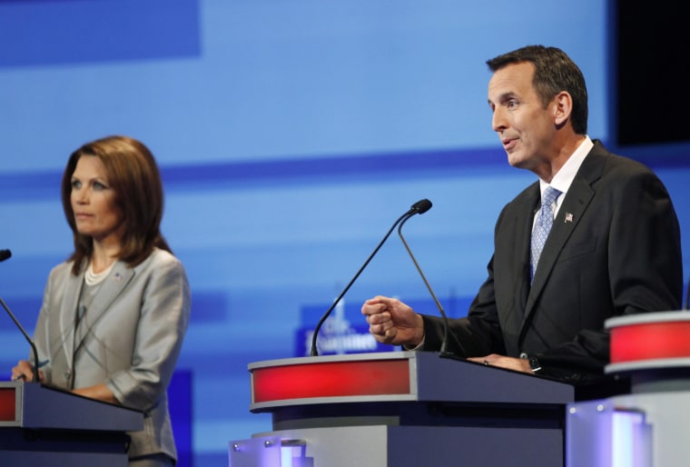 Image: U.S. Republican presidential candidate Tim Pawlenty speaks beside Michele Bachmann during the Republican presidential debate in Ames