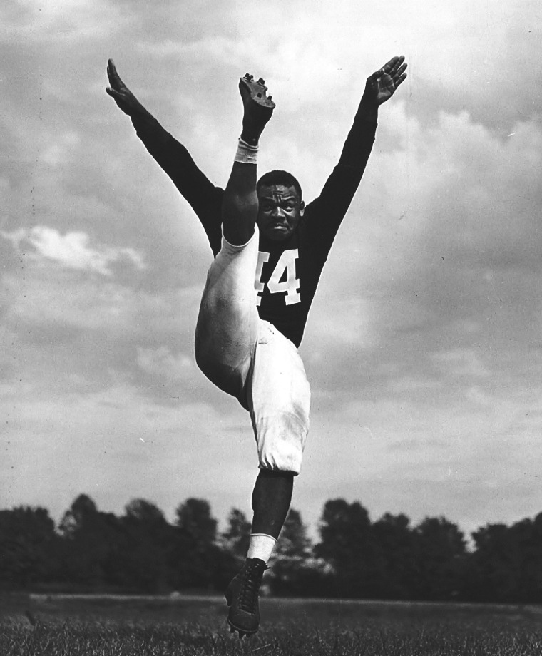George Taliaferro punting for Indiana University. He would go on to become the first African-American drafted by the NFL.