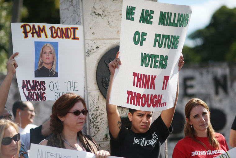 Image: Activists Demonstrate Against FL's Attorney General Pam Bondi Backing Of Lawsuit Against Obama's Immigration Action