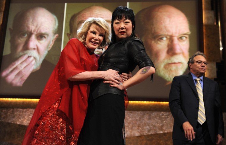 Image: Comedians Rivers and Cho embrace at tribute for late stand-up comedian Carlin at Kennedy Center in Washington