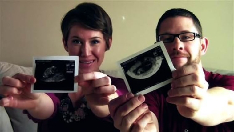 The Bakers hold a sonogram photo of baby #3, who is coming in September.