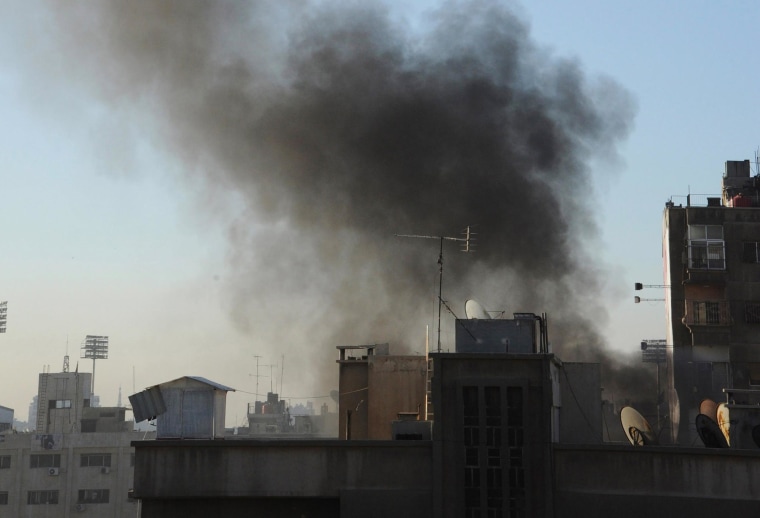 Image: Smoke rises from a site hit by rockets in Damascus