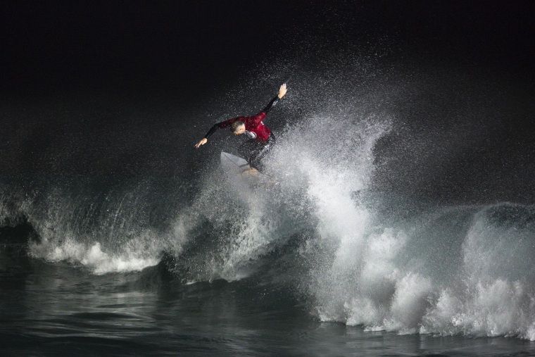 Image: A surfer rides a wave during a night-surfing competition in Ashdod