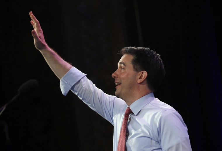 Image: Wisconsin Governor Walker waves to the crowd as he arrives to speak at the Freedom Summit in Des Moines
