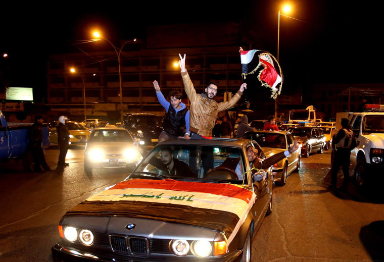 Image: Iraqis celebrate after the lifting of the night-time curfew