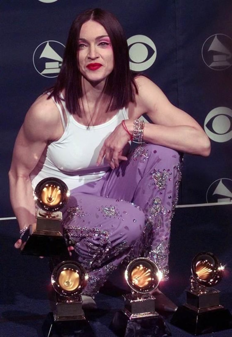 Madonna poses with her four Grammy Awards backstage on Feb. 24, 1999.