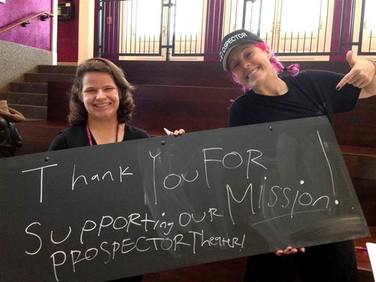 Juliette Barberie, a theater employee who loves art, makes a new Concessions sign with Valerie Jensen, the organization's founder.