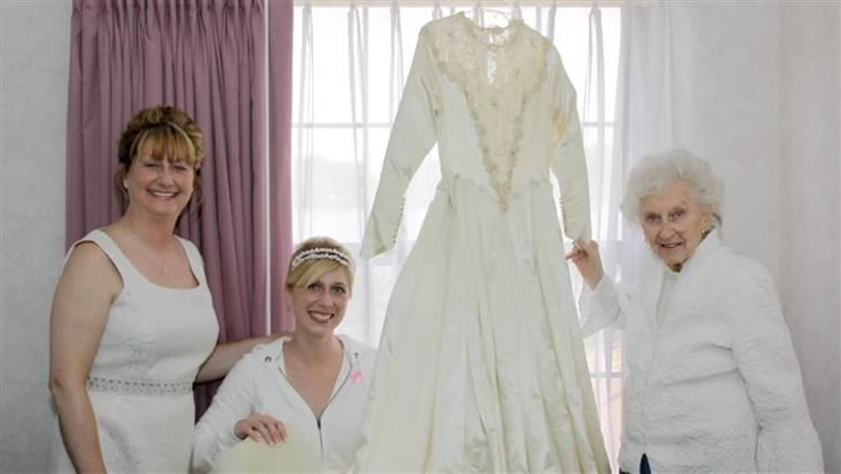 Cindy, Jackie, and Helene pose with their wedding dress.