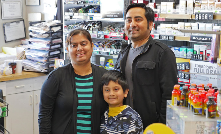 Chandra Siwakoti, owner of the Appletree Food Mart in Princeton, Texas, poses with his wife Smriti Acharya and son Aryan on Feb. 12 after it was announced that a winning Powerball ticket had been sold at the story. When Chandra pulled up at the store in the early morning, he saw the news trucks and reporters and thought he had been robbed.