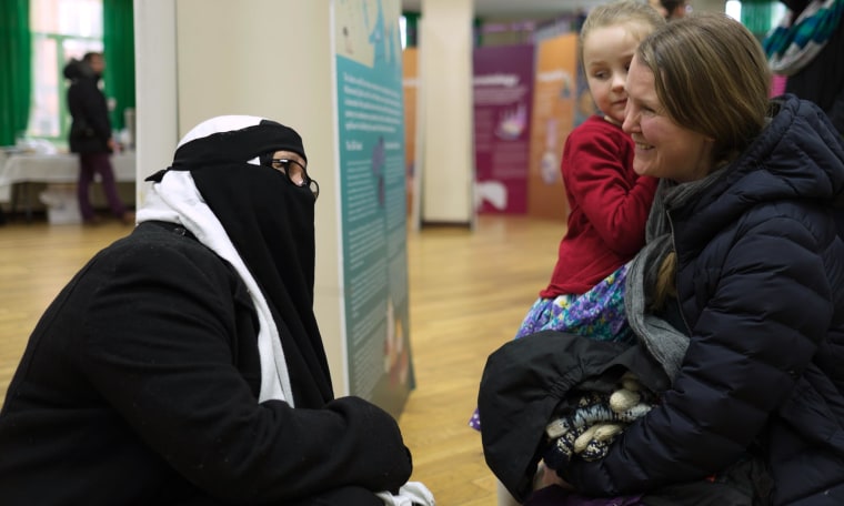 Image: A volunteer speaks to visitors on “Visit My Mosque Day” at Finsbury Park Mosque in north London.
