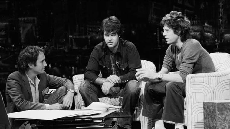 Lorne Michaels in 1978 with cast member Dan Aykroyd and guest Mick Jagger, rehearsing a skit on the "SNL" set.