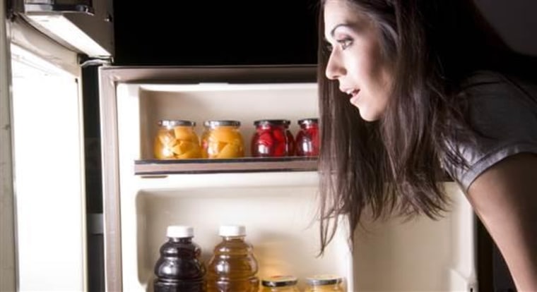 An attractive woman raids the refrigerator late at night looking for a food snack; Shutterstock ID 93209830; PO: MC for TODAY Health