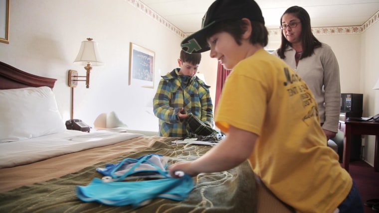 Kelley Ericson and her two kids moved into a hotel on short notice after their apartment building suffered a partial roof collapse from heavy snow in Portsmouth, N.H.