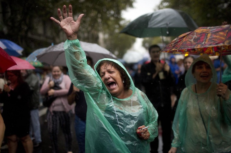 Image: A protester chants anti-government slogans during a march