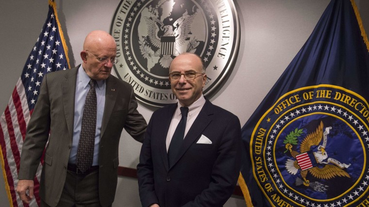 Image: US Director of National Intelligence James Clapper (L) greets French Interior Minister Bernard Cazeneuve