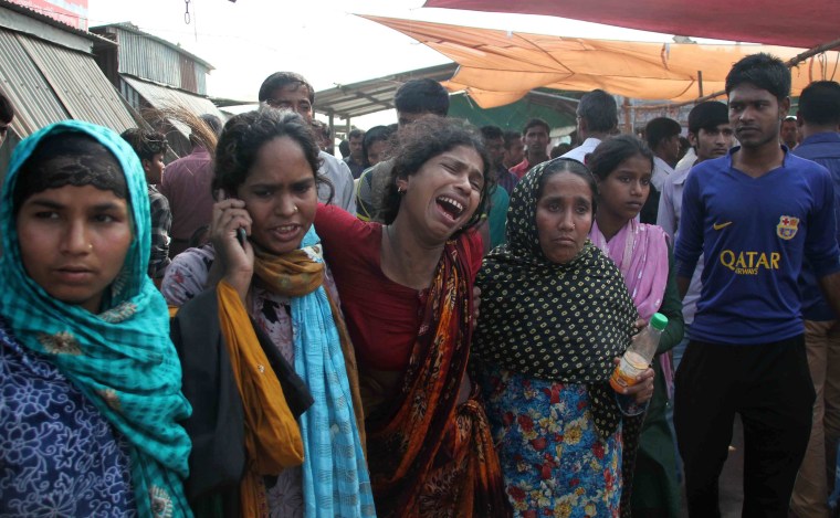 Image: Bangladesh relatives cry as they mourn the death of ferry accident victims