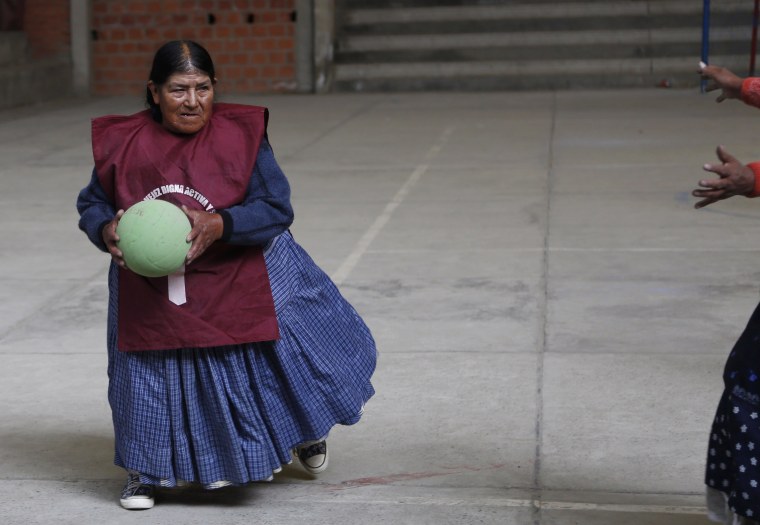 In this Feb. 11, 2105 photo, elderly Aymara indigenous women play handball  in El Alto, Bolivia. Team handball is an Olympic sport in which two teams  of pass a ball using their