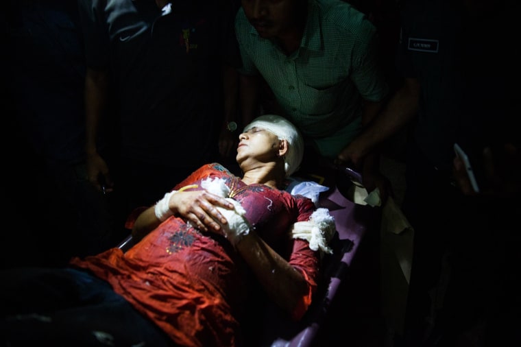 Image: Avijit Roy's wife Rafida Ahmed Banna is carried on a stretcher