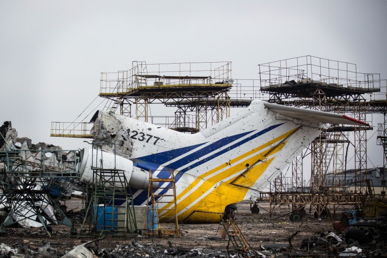 Destroyed commercial airplanes sit scattered on the runway of Donetsk Airport.