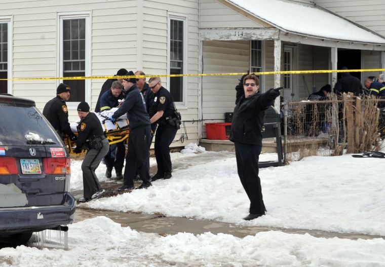 Emergency personnel work to save four young victims of carbon monoxide poisoning in Troy, Ohio, on Feb. 27.