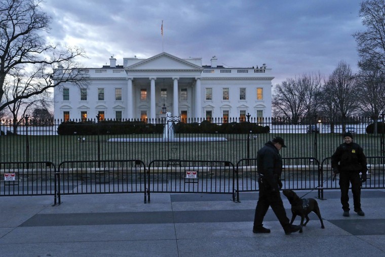 Image: Secret Service Uniformed Division officers patrol in front of the White House in Washington
