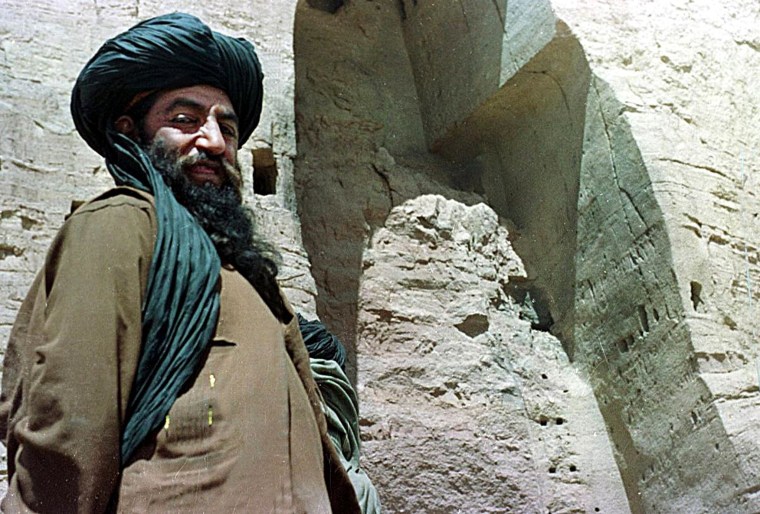 Image: Unidentified Taliban official near destroyed Buddha statue on March 26, 2001