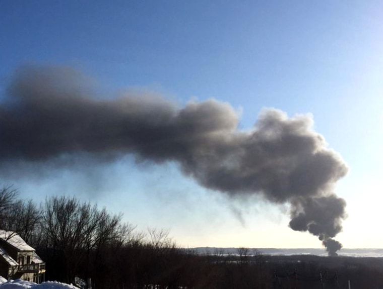 Smoke rises from the scene of a train derailment near Galena, Illinois, Thursday. The train was carrying crude oil, and at least two train cars caught fire, authorities said.