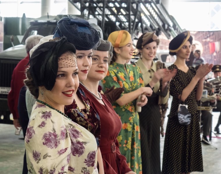 Image: Amateur models walking the catwalk in vintage WWII-era dresses