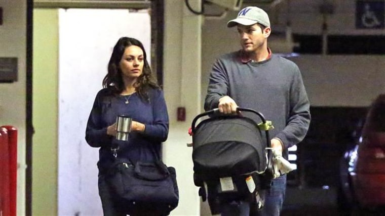 Ashton Kutcher enjoying a day out with Mila Kunis as he carries their baby daughter Wyatt in Los Angeles, California.