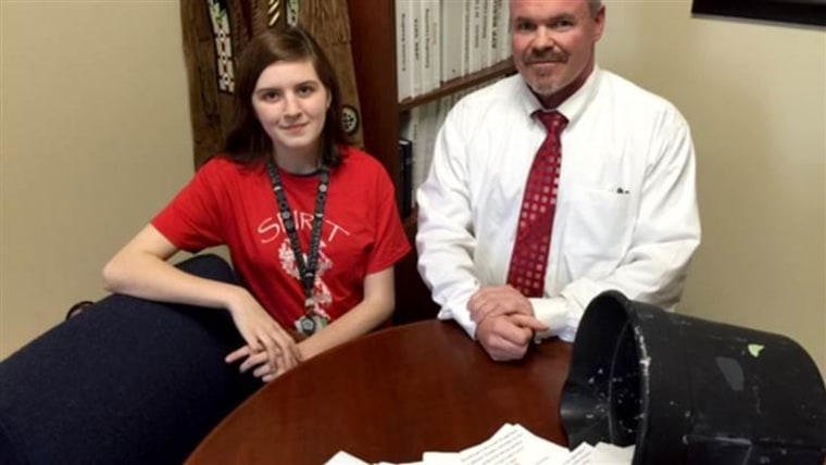 For a "prank," Wichita High School North senior Emily Jones led her classmates in making their principal, Sherman Padgett, stand in the hallway and hold an empty bucket, which they filled with almost 100 thank-you notes.