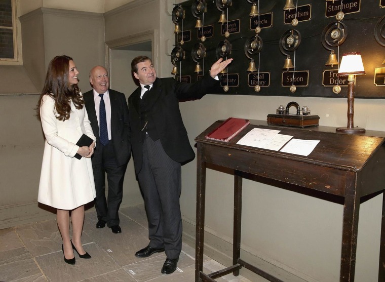 Image: Britain's Catherine, Duchess of Cambridge, is shown the Downton Abbey servants bells by actor Brendan Coyle (who plays John Bates) during an official visit to the set of Downton Abbey at Ealing Studios, west of London