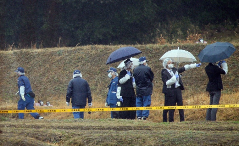 Image: Police officers investigate stabbing deaths in Sumoto, Japan